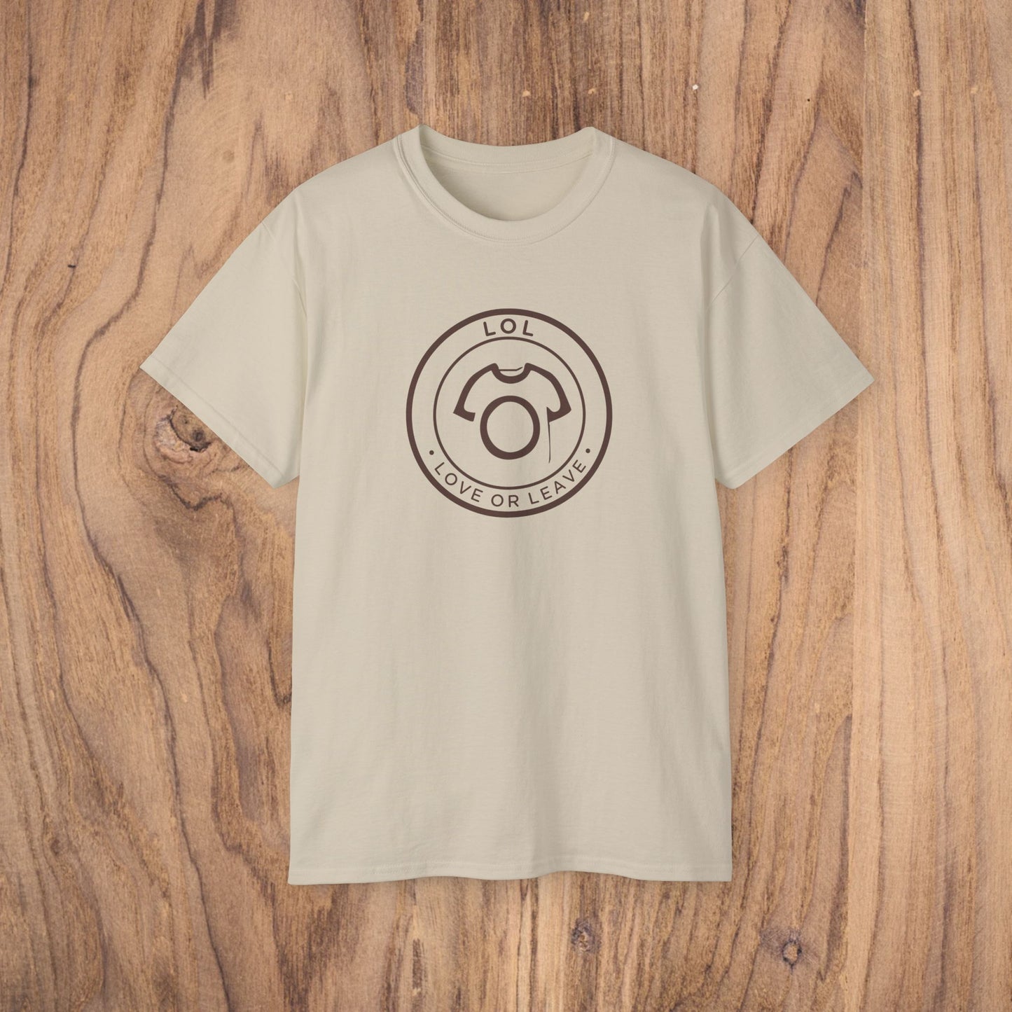 Beige t-shirt with a black logo on a wooden surface